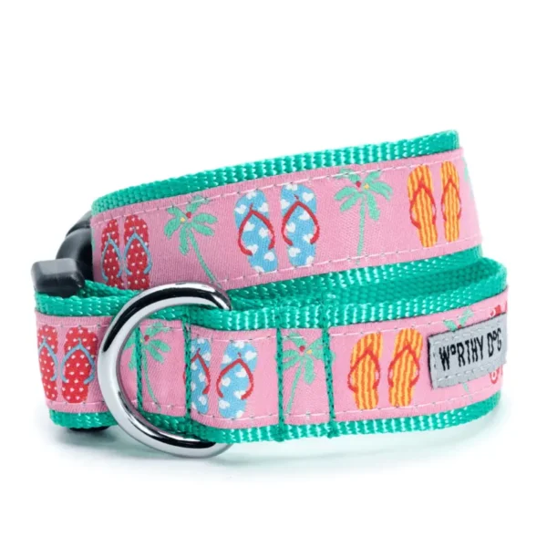 A colorful dog collar featuring a pink background with patterns of flip-flops and palm trees.