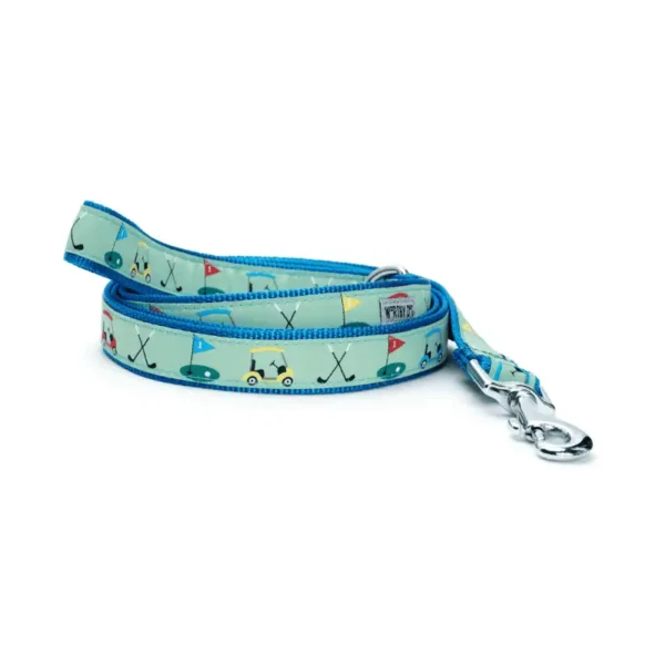 A colorful dog leash featuring playful patterns of golf carts, flags, and golf clubs.