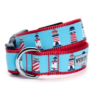 A dog collar featuring a light blue background with red lighthouses and a red strap.