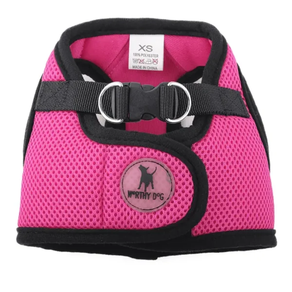 A pink dog harness with a mesh design, featuring a buckle and D-rings for leash attachment.