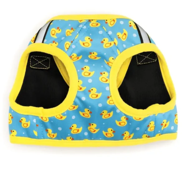 A dog harnesss featuring a blue fabric with yellow rubber duck patterns and yellow trim. With 2 arm holes.