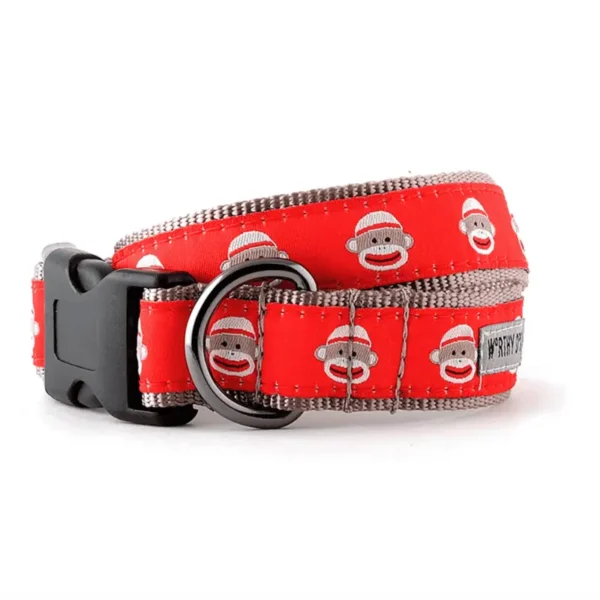 A red dog collar featuring playful sock monkey designs.