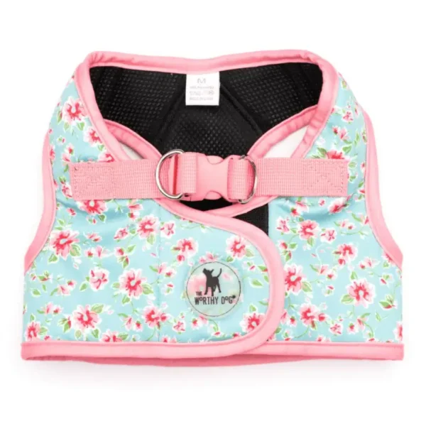A floral-patterned dog harness with pink trim and a D-ring for leash attachment.