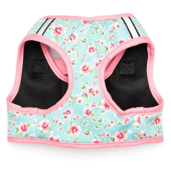 A floral-patterned dog harness in light blue with pink trim and black mesh panels.