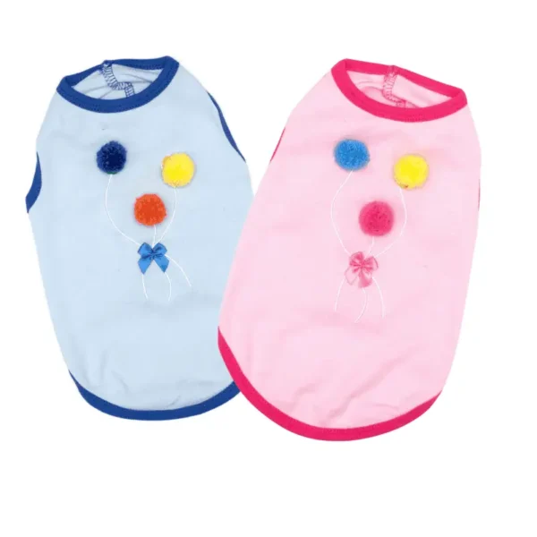 Two dog shirts in blue and pink, each adorned with colorful pom-poms and decorative embroidery.
