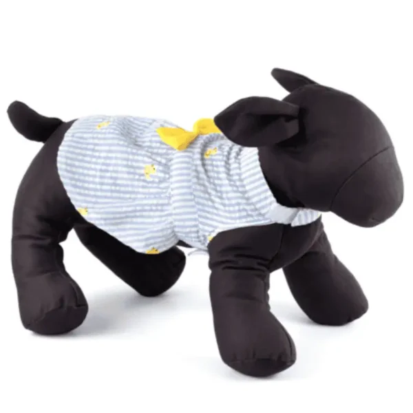 A plush dog mannequin wearing a striped dress with yellow duck accents.
