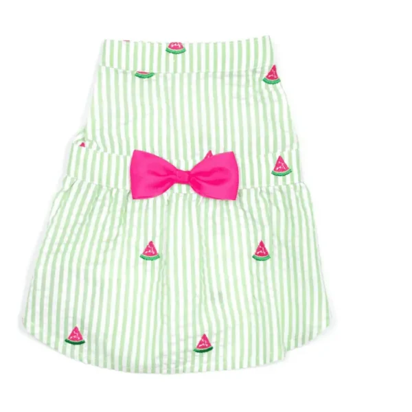 A green and white striped dog dress featuring small watermelon designs and a large pink bow at the waist.