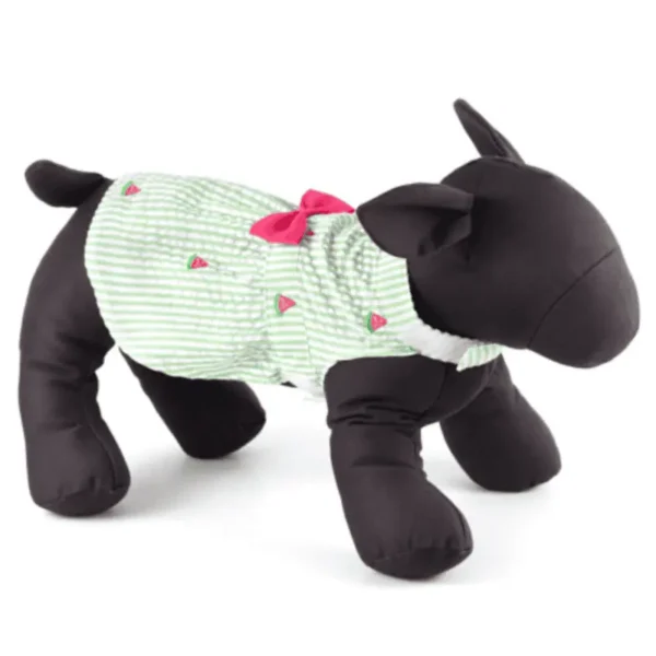 A plush dog mannequin wearing a green striped shirt with a pink bow and watermelon slices design.