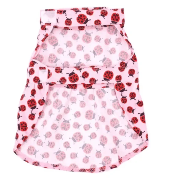 A pink dog dress with a ladybug pattern.