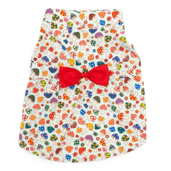 A colorful dog dress with a pattern of mushrooms and a red bow.