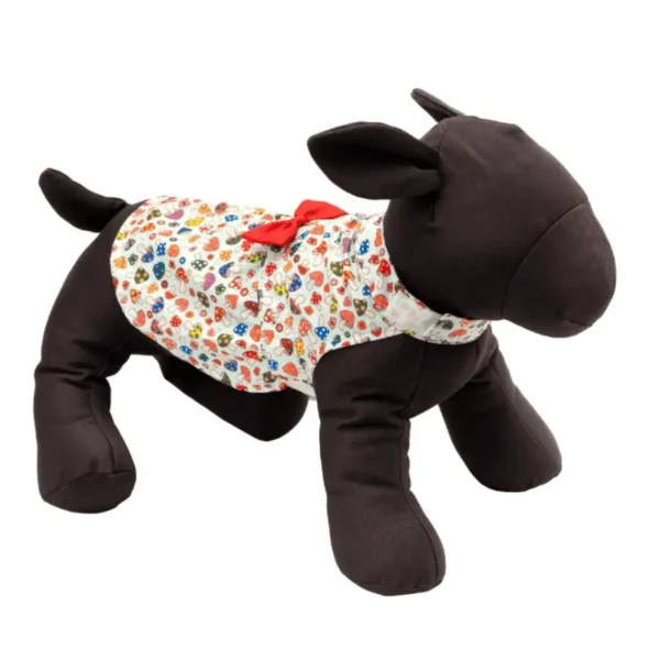 A plush dog mannequin with a black body and wearing a colorful, mushroom-patterned dress.