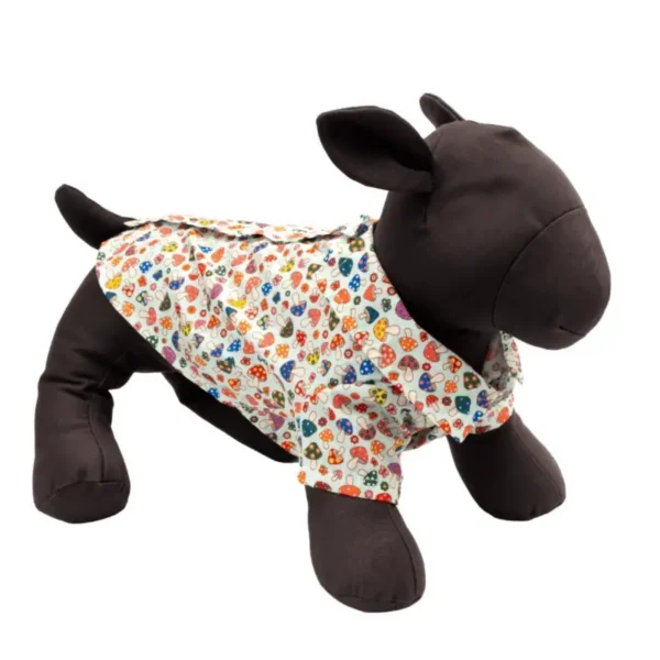 A plush dog mannequin wearing a colorful, mushroom-patterned shirt.