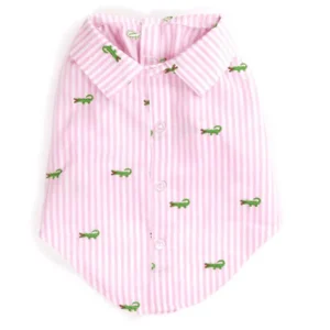 A pink striped dog shirt featuring small green crocodile patterns.