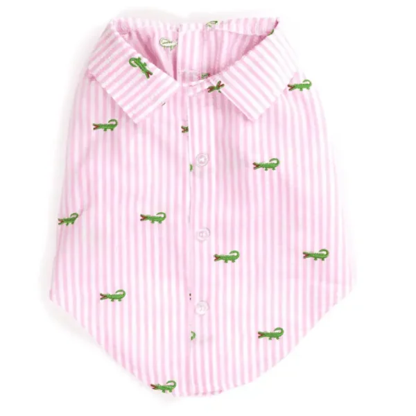 A pink striped dog shirt featuring small green crocodile patterns.