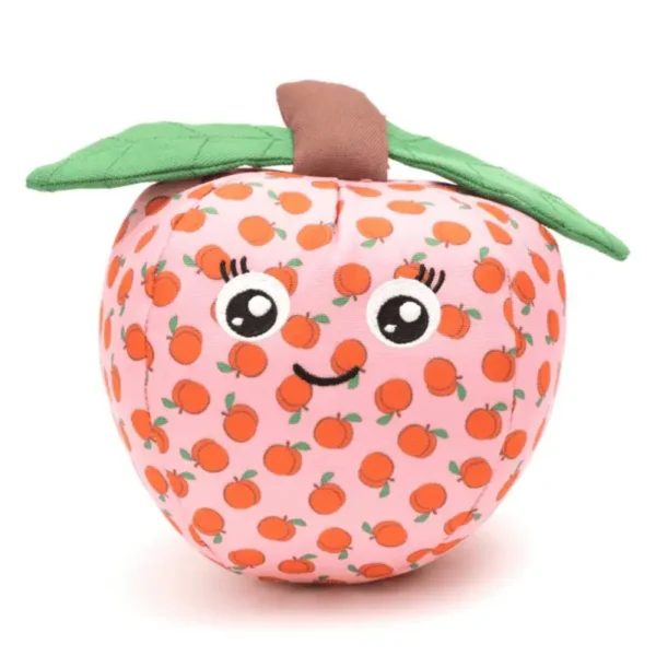 A cute, plush peach dog toy with a pink base, smiling face, and green leaves, decorated with small orange fruit patterns.