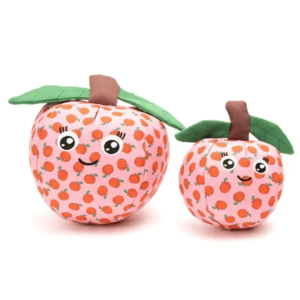 Two plush dog toys shaped like peaches, one larger with a smiling face and one smaller with a happy expression. Both have green leaves.