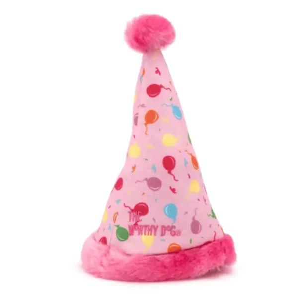 A pink dog party hat with colorful balloon designs and a fluffy pink trim.