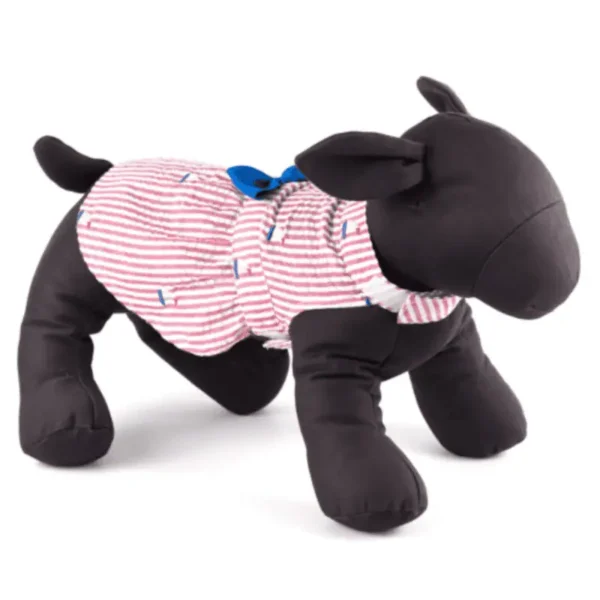 A plush dog mannequin wearing a striped dress and a blue bow.