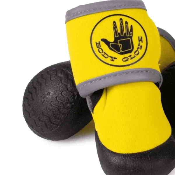 A pair of yellow and black dog boots with a logo on them.
