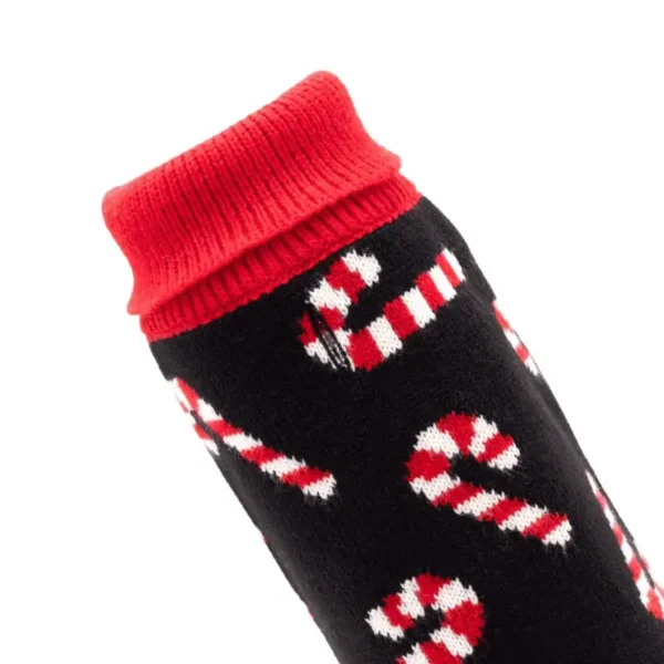 A close-up of a black dog sweater with a red turtleneck, featuring a candy cane pattern.