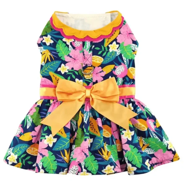 A colorful dog dress with a floral pattern, featuring pink flowers, green leaves, and a yellow bow at the waist.