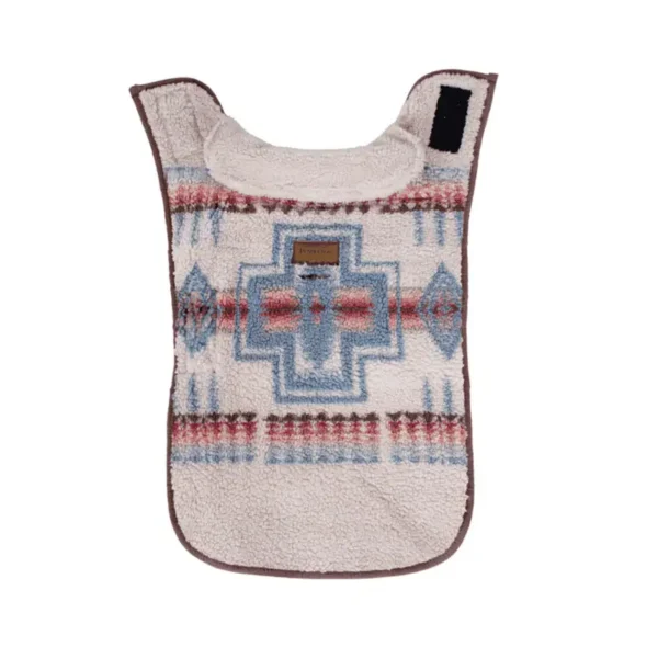 A decorative, patterned dog coat with a geometric design in shades of blue and red on a cream background.
