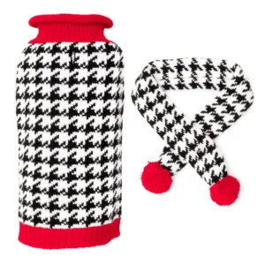 A matching set of winter accessories featuring a black and white houndstooth-patterned dog sweater and a scarf with red pom-poms.
