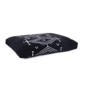 A black decorative dog bed with a tribal geometric white pattern.