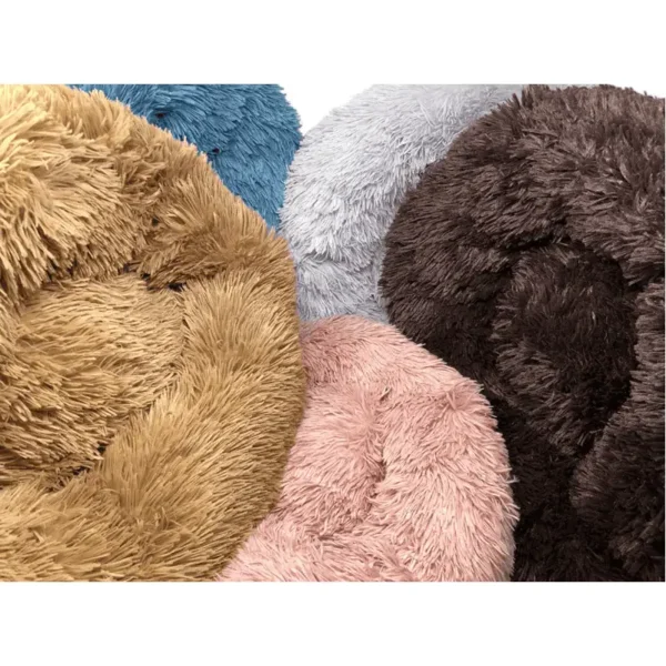 A collection of fluffy, round dog beds in various colors: tan, blue, gray, pink, and brown.