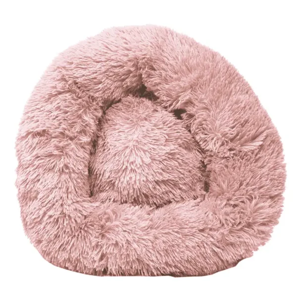 A soft, round, pink plush dog bed.