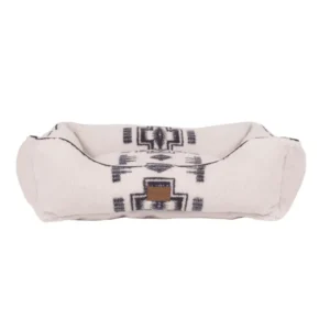 A cozy dog bed with a cream background and a geometric black pattern.