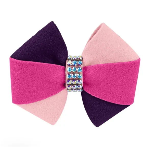 A colorful dog hair bow featuring shades of pink, purple, and rhinestones accents in the center.