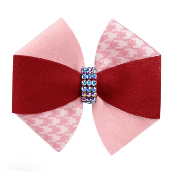 A decorative bow featuring two shades of pink and red, and the center is adorned with rhinestones.
