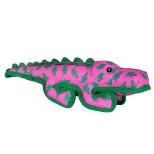 A playful plush alligator dog toy, pink with green accents and small crocodile prints, features a friendly face and soft, textured body.
