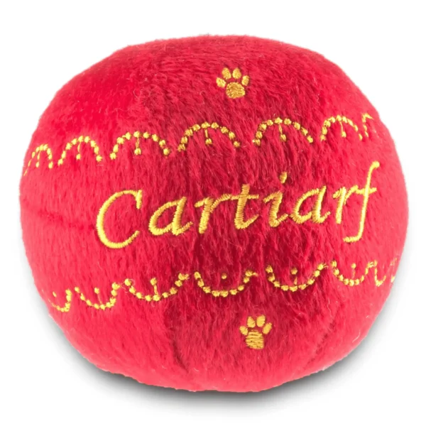 Red plush ball dog toy with gold designs, paw prints, and Cartiarf text