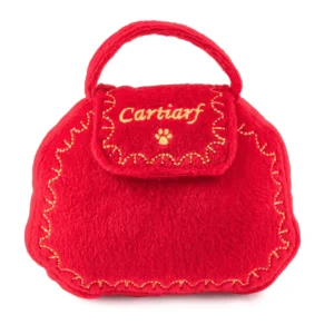Plush red purse dog toy with gold designs, paw print, and Cartiarf text