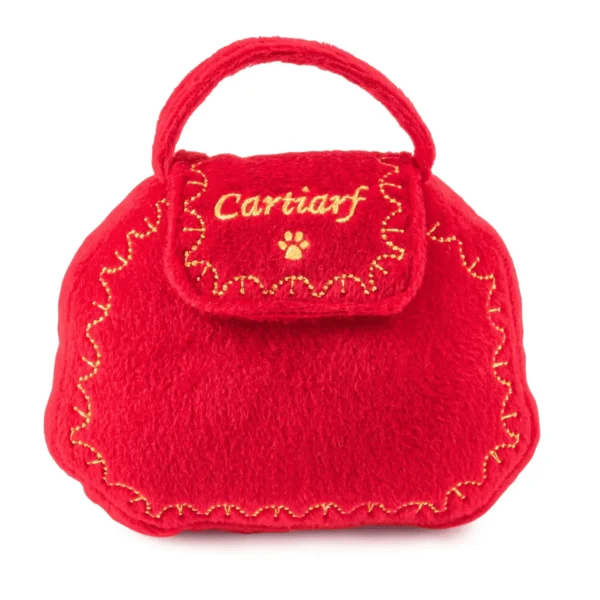 Plush red purse dog toy with gold designs, paw print, and Cartiarf text