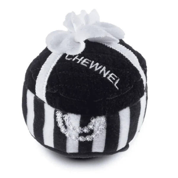 Plush black Chewnel Gift Box dog toy with white stripes, white ribbon, white flower, white “CHEWNEL” text, and white embroidered pearl accents. Soft squeaky toy for stylish pups