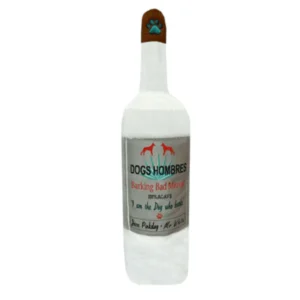White plush mezcal bottle dog toy with gray Dogs Hombres Barking Bad label and black cap