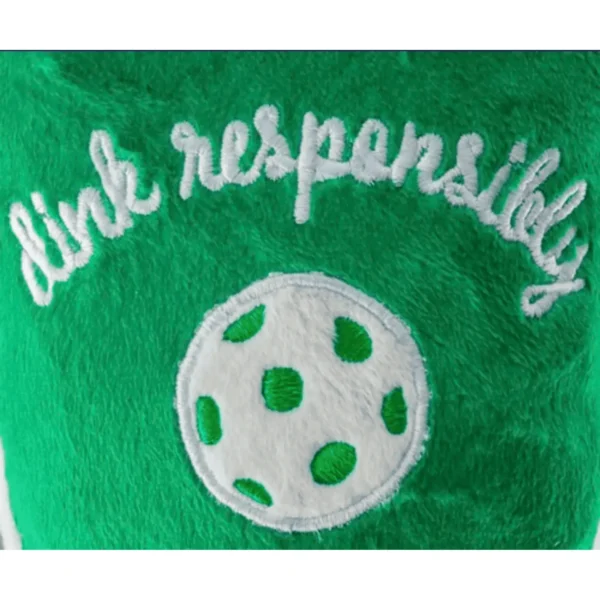 Green Pickleball Paddle Dog Toy – close up showing white embroidered ‘Drink Responsibly’ and white pickleball on plush paddle