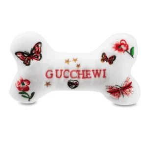 White plush bone dog toy with embroidered flowers, butterflies, and Gucchewi text