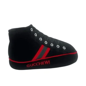Plush black Gucchewi Sneaker dog toy with black laces, silver eyelets, red stripes, and red embroidered “Gucchewi” text. Soft squeaky toy for playful pups.