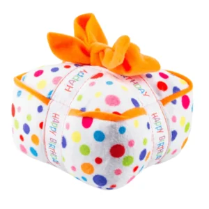Happy Birthday Gift Box Dog Toy – plush white polka dot gift box with white ribbon featuring rainbow words ‘Happy Birthday’ and orange ribbon squeaky toy for dogs