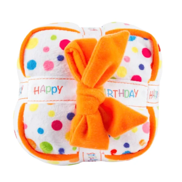 Happy Birthday Gift Box Dog Toy – top view of plush white polka dot gift box with white ribbon featuring rainbow words ‘Happy Birthday’ and orange ribbon