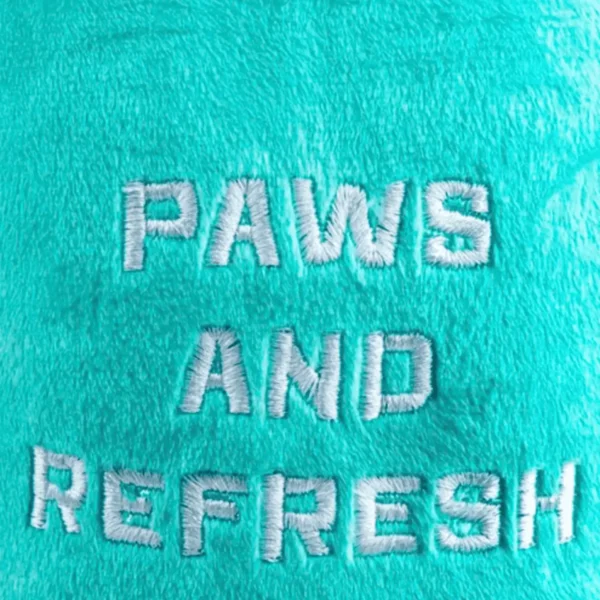 Close-up of white 'Paws And Refresh' on plush teal cup