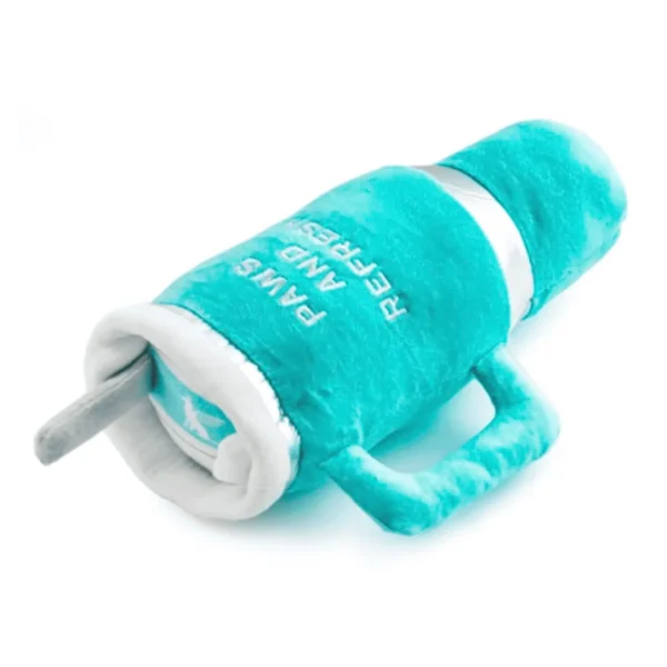 Lying flat, slanted of Teal plush cup dog toy with white embroidered “Snuggly” text