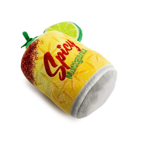 Slanted view of Yellow plush margarita cup dog toy with salt rim and lime wedge accent.