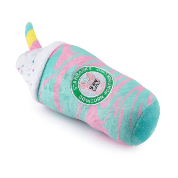 Lying down and slanted angle of Plush frap cup dog toy with rainbow straw, whipped cream, and colorful swirls