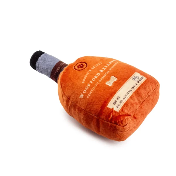Plush bourbon bottle dog toy with label embroidery lying angled with squeaker