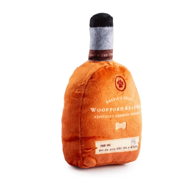 Plush bourbon bottle dog toy with label embroidery slanted view of plush bourbon bottle squeaky toy